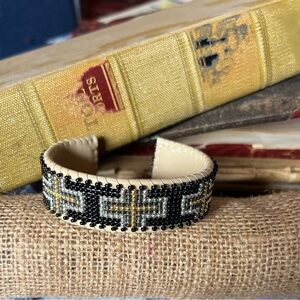 Faded cuff on copper covered with leather.